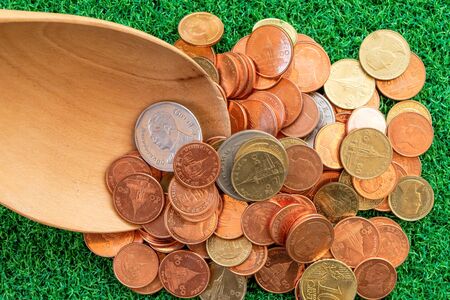 coin in wooden spoon in business conceptの写真素材