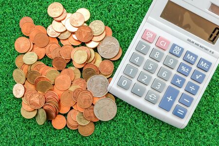 coin with calculator in business conceptの写真素材