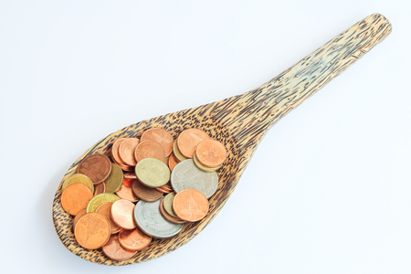 coin in wooden spoon with business conceptの写真素材