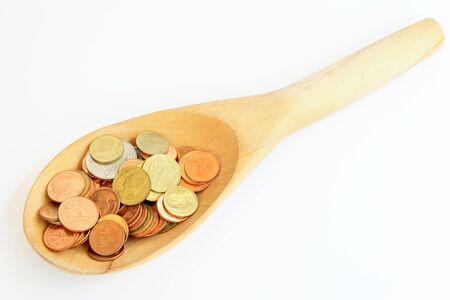 coin in wooden spoon with business conceptの写真素材