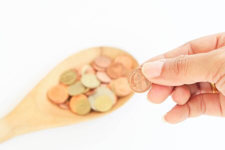 coin in wooden spoon with business conceptの写真素材