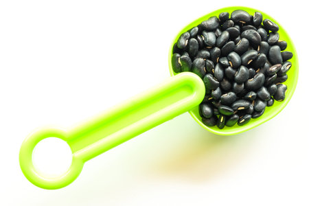 black bean on plastic spoon healthy concept