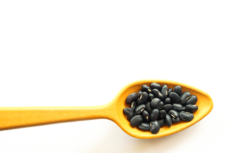 black bean on wooden spoon healthy conceptの写真素材