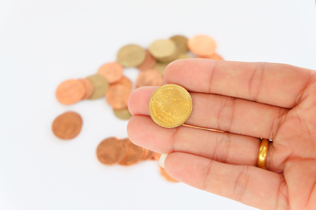 coin in wooden spoon in business conceptの写真素材
