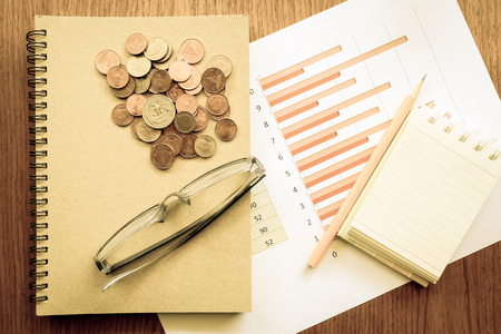 chart and money on wooden table with vintage styleの写真素材
