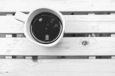 black coffee on wooden table with black and white colorの写真素材