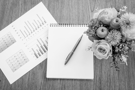 book and graph on wooden with black and white colorの写真素材