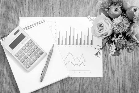 book and graph on wooden with black and white colorの写真素材