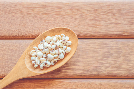 Job's tears on wooden background with vintage colourの写真素材