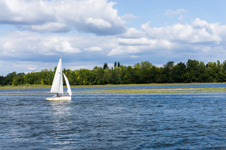 Sailboat sailing on the river. Gennes-Val-de-Loire, Loire, Loire, Maine-et-Loire. French.の写真素材