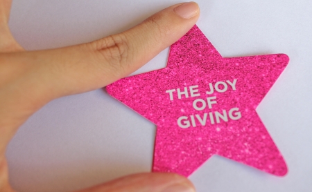 Finger touch a The Joy of Giving Star の写真素材