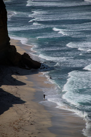 Local fisherman walks peru beach placing nets traps to provide food for his family traditional...
