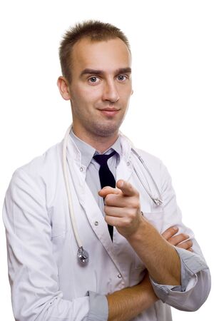 young male doctor with stethoscope pointing at youの写真素材