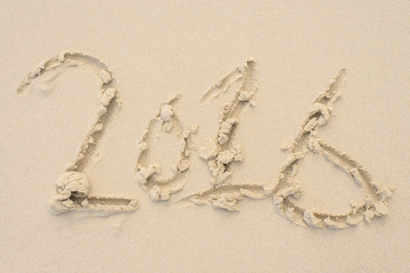 Happy New Years 2016 on the sand background Texture. Beach background. Top viewの写真素材