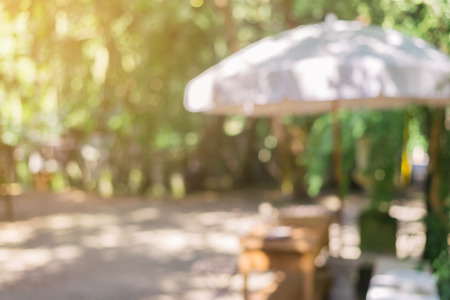 Blurred background - Coffee shop in garden blur background with bokeh. Vintage filtered image.の写真素材