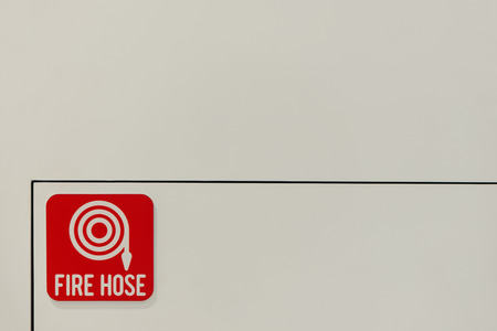 Fire hose symbol on the wall.の写真素材