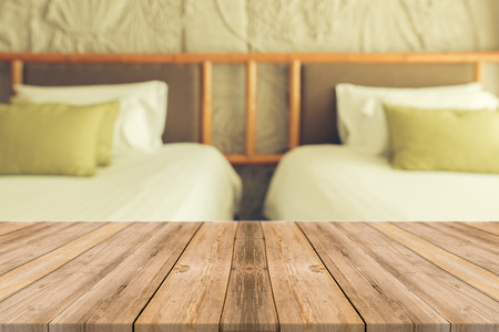 Wooden board empty table in front of blurred background. Perspective brown wood over blur bedroom - can be used for display or montage your products.Mock up for display of product.の写真素材