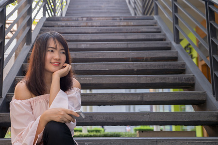 Young smiling woman outdoors portrait. Soft sunny colors.Close portrait. beautiful smiling girl. Woman in the city in summertime. Summer outdoor portraitの写真素材