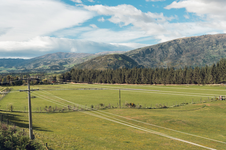 Straight empty highway leading into Aoraki-Mount Cook National Park to the highest peaks of the Southern Alps lining the horizon, South Island of New Zealand, Vintage filtered image.の写真素材