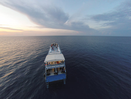 Amazing view to cruise boat sailing in open sea at windy day. Aerial photo drone view - birds eye...