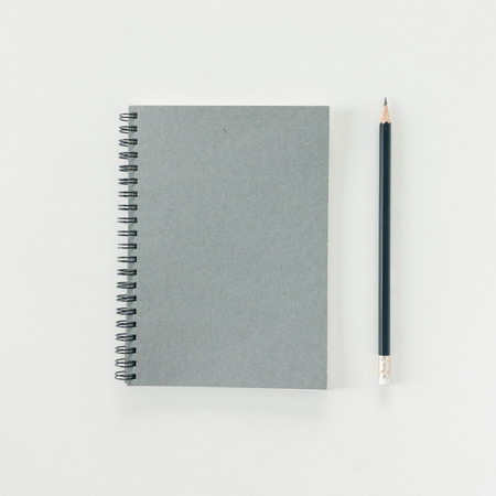 Minimal work space - Creative flat lay photo of workspace desk with sketchbook and wooden pencil on copy space white background. Top view , flat lay photography.の写真素材