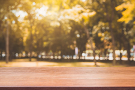 Wooden board empty table in front of blurred background. Perspective brown wood table over blur...