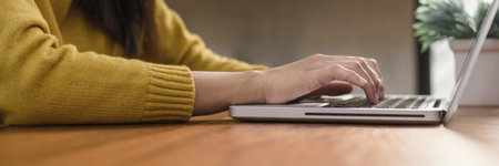 Young woman working with the laptop on a desk in coffee shop. Young woman working on weekend with...