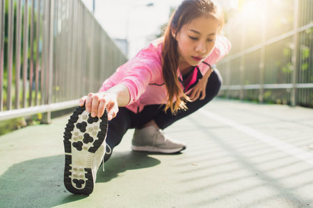 Fitness sport girl fashion sportswear doing yoga fitness exercise in street. Fit young asian woman...