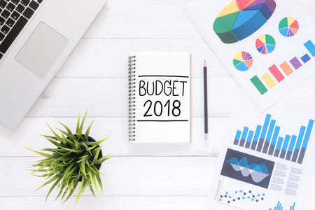 Minimal Work space - Flat lay view photo of working desk with a business budget plan of a new year...