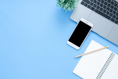 Office desk working space - Flat lay top view mockup photo of working space with laptop, smartphone...