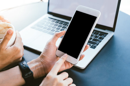 Young Asian woman using smartphone mock up blank black screen in cafe. Lifestyle women communication...