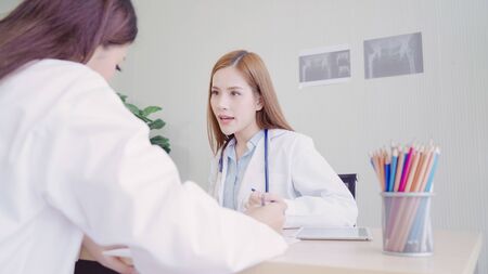 Professional Asian doctor medical professionals team brainstorming in a meeting. Team of healthcare workers discussing in boardroom at hospital. Health care and assistance concept.の写真素材