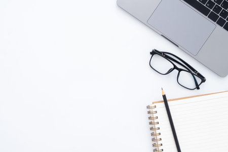 Creative flat lay photo of workspace desk. Top view office desk with laptop, glasses, pencil,...