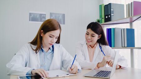 Professional Asian doctor medical professionals team brainstorming in a meeting. Team of healthcare workers discussing in boardroom at hospital. Health care and assistance concept.の写真素材
