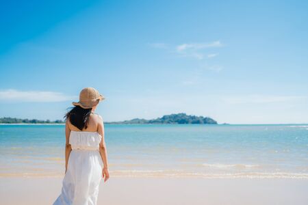 Beautiful young Asian woman happy relax walking on beach near sea. Lifestyle women travel on beach concept.の写真素材
