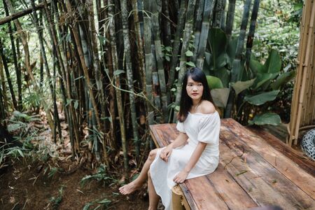 Young Asian woman relax in forest, Beautiful female happy using relax time in nature. Lifestyle women travel in forest concept.の写真素材