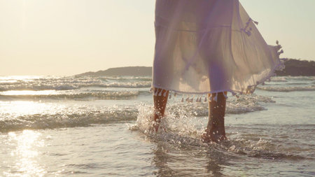 Young Asian woman walking on beach. Beautiful female happy relax walking on beach near sea when...