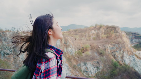 Hiker Asian backpacker woman on top of mountain, Female enjoy her holidays on hiking adventure feeling freedom. Lifestyle women travel and relax in free time concept.の写真素材