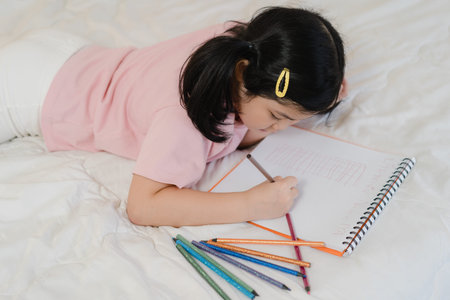 Young Asian girl drawing at home. Asia japanese woman child kid relax rest fun happy draw cartoon in...