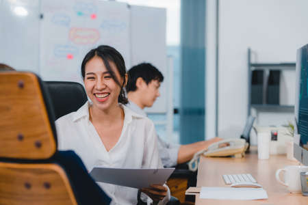 Asia businesspeople chatting to intern discussing job interview colleagues having conversation and communication meeting brainstorming ideas about project working plan success strategy in office.の写真素材