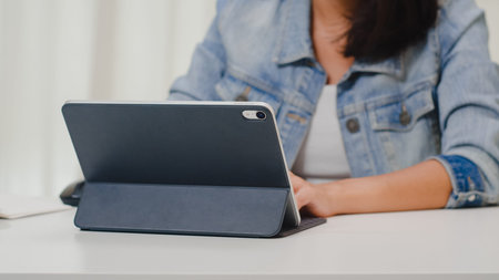 Portrait of freelance smart business women casual wear using tablet working in workplace in living...