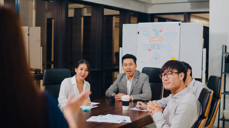 Asia businessmen and businesswomen meeting brainstorming ideas conducting business presentation...