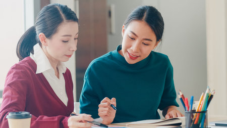 Group of Asia young creative people Japanese female boss supervisor teaching intern or new employee...