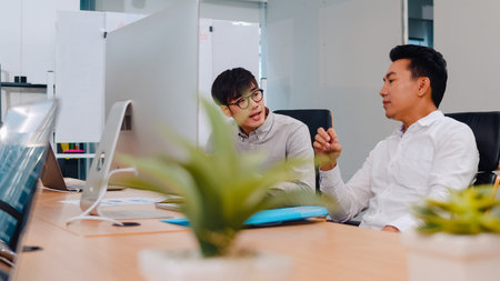 Asia businesspeople chatting to intern discussing job interview colleagues having conversation and...
