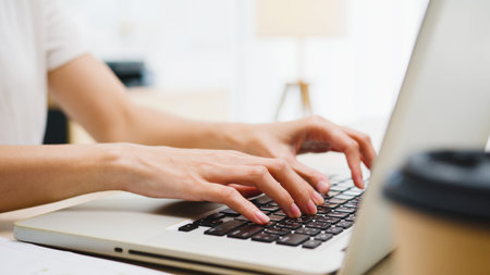 Freelance young Asia businesswoman casual wear using laptop working in living room at home. Working...