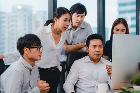 Collaborative process of multicultural business people using computer presentation and communication meeting brainstorming ideas about project colleagues working plan success strategy in modern office.の写真素材