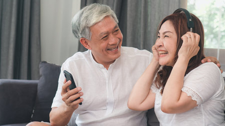 Asian senior couple relax at home. Asian Senior Chinese grandparents, husband and wife happy wear...