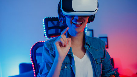 Happy asia girl wear virtual reality glasses goggles headset feel surprise real game program in her...