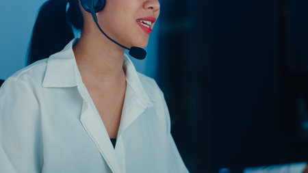 Millennial Asia young call center agent or customer support service executive using computer and...