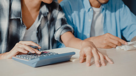 Stress asia couple man and woman use calculator for calculate family budget, debts, monthly expenses...
